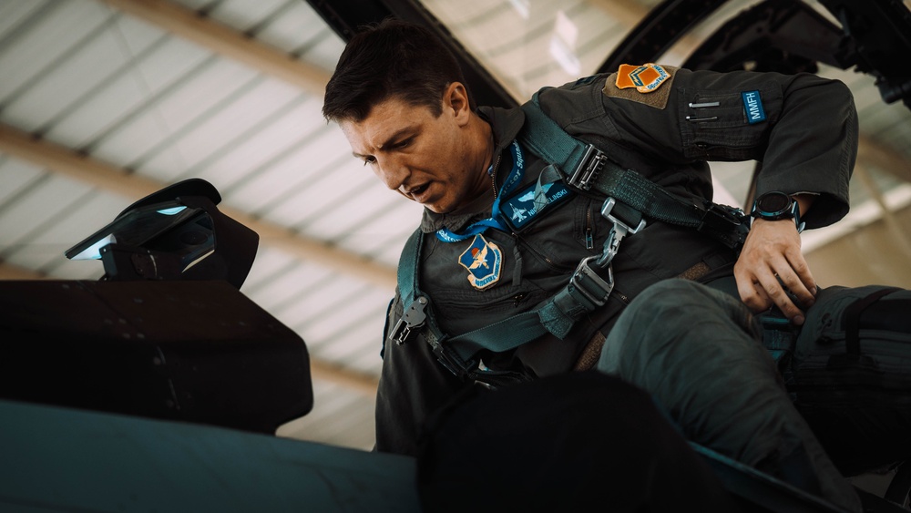 Military pilot entering cockpit