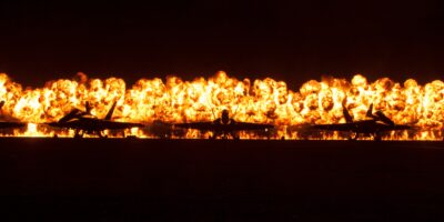 Wall of fire behind Blue Angels aircraft during a night air show at MCAS Miramar